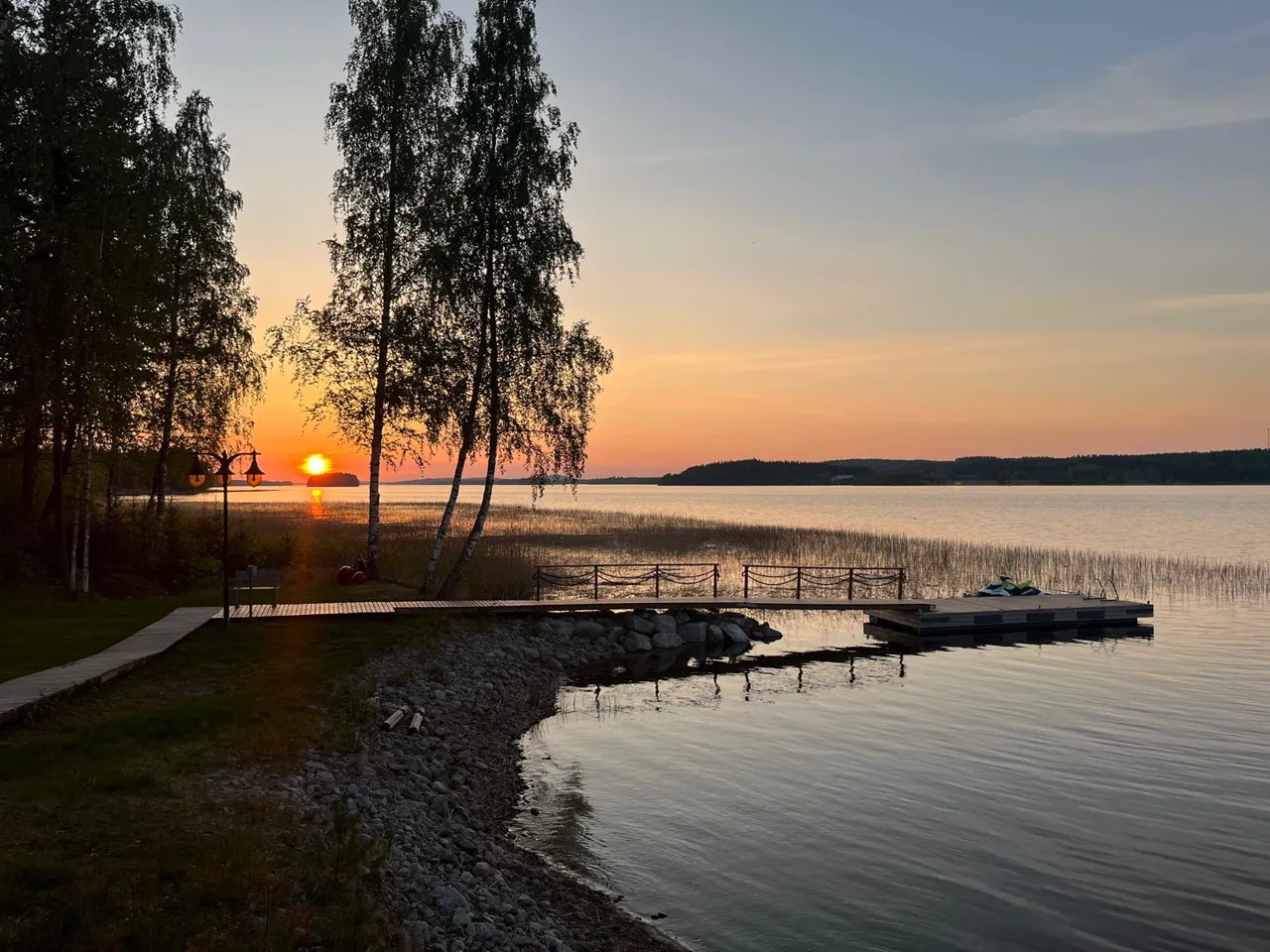 Auringonlasku Kallavedellä — koivut ja laituri
